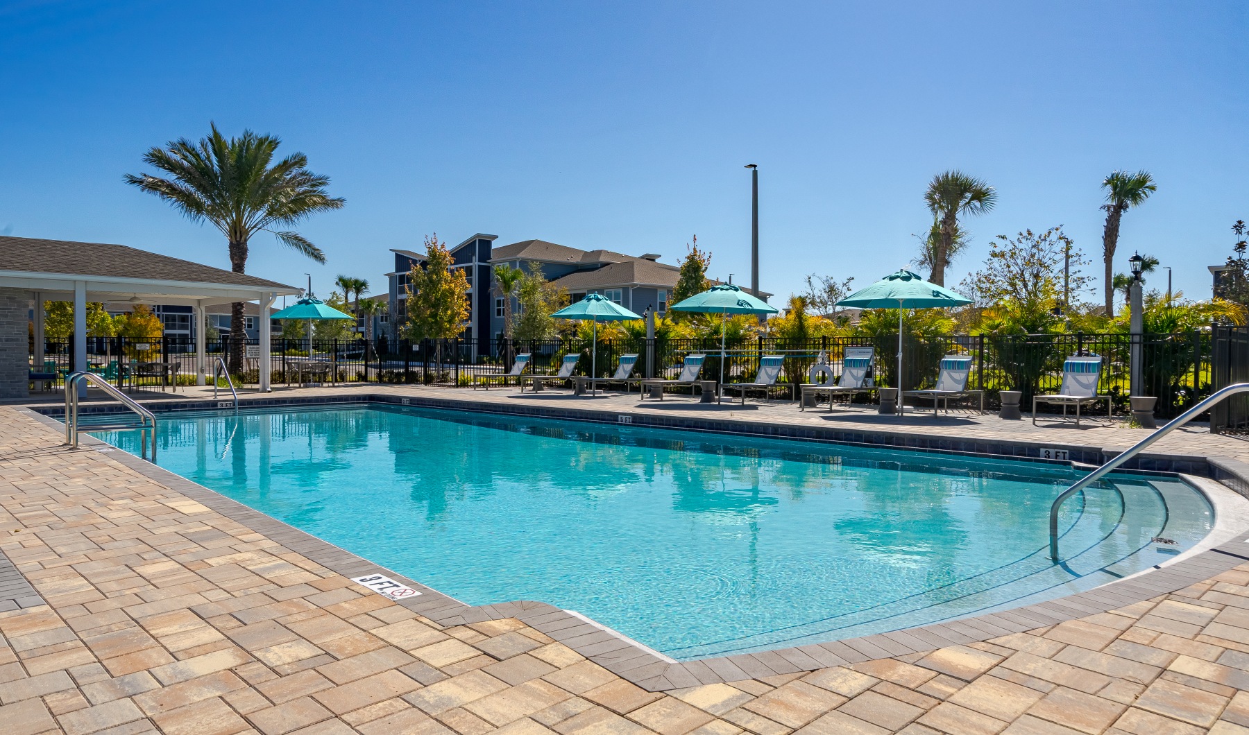 view of pool deck with lounge chairs